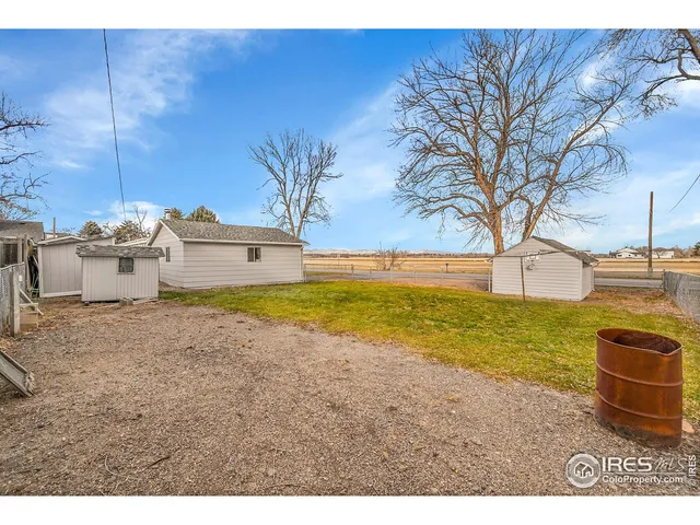 a view of a backyard with wooden fence