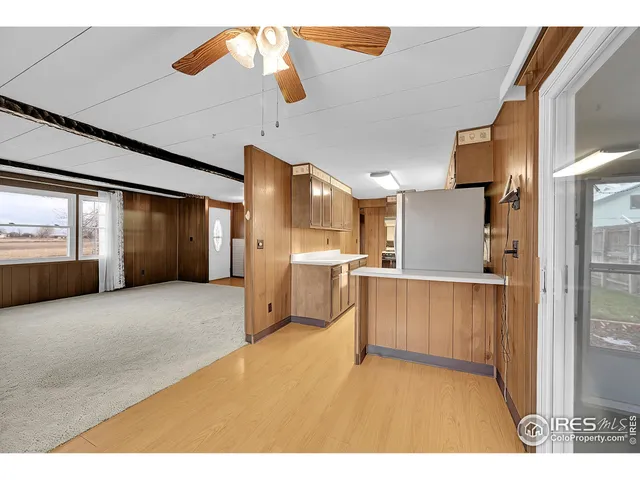 a view of a kitchen with a sink and a refrigerator