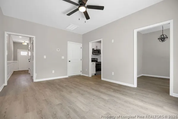 an empty room with closet and windows