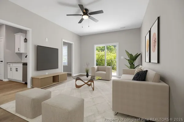 a living room with furniture and a flat screen tv