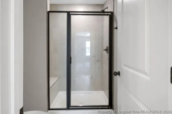 a bathroom with a glass shower door
