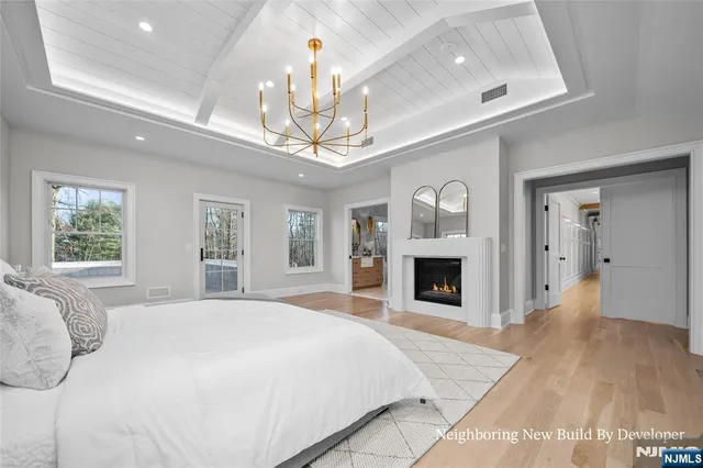 a bedroom with a large bed and a fireplace