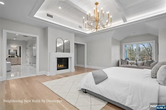 a bedroom with a large bed and a fireplace