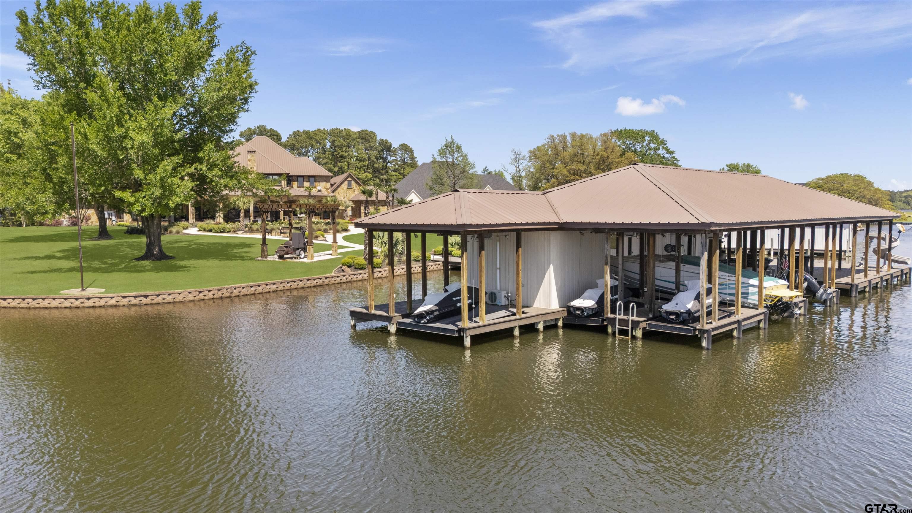 17873 Slack Road Whitehouse, TX 75791 - Photo 19 of 48 a view of a swimming pool with lawn chairs under an umbrella