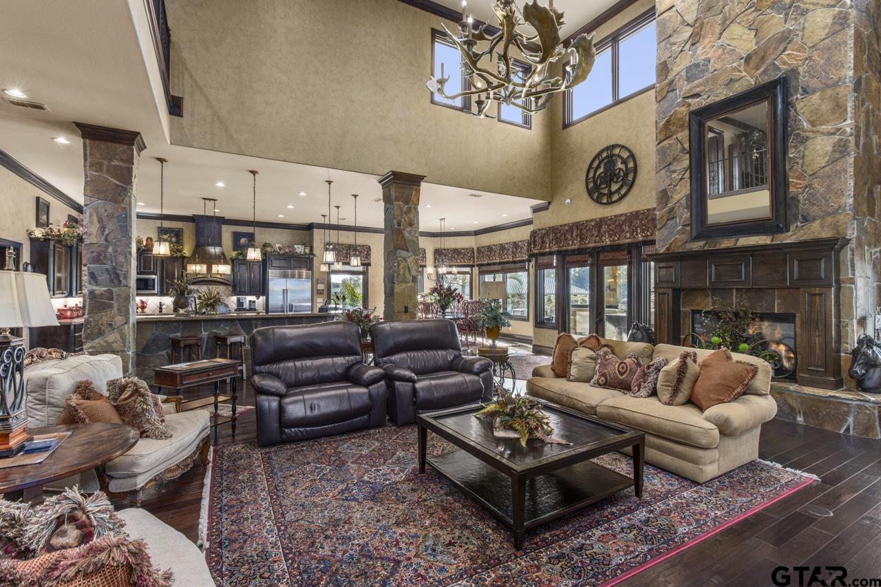 17873 Slack Road Whitehouse, TX 75791 - Photo 31 of 48 a living room with furniture a fireplace and a chandelier