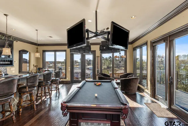 a kitchen with stainless steel appliances granite countertop a stove and a view of living room