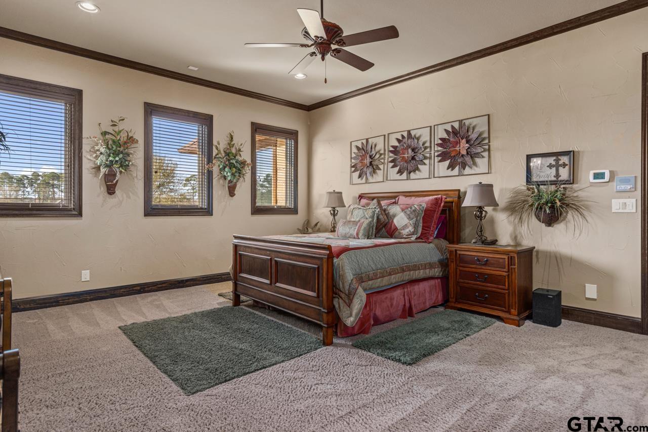 17873 Slack Road Whitehouse, TX 75791 - Photo 45 of 48 a bedroom with a bed and a chandelier