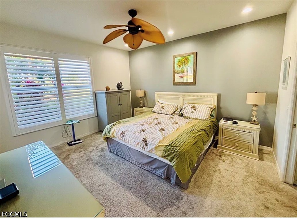 14971 Rivers Edge Court, Unit 101 Fort Myers, FL 33908 - Photo 9 of 15 a bedroom with a bed and a chair with the wooden floor