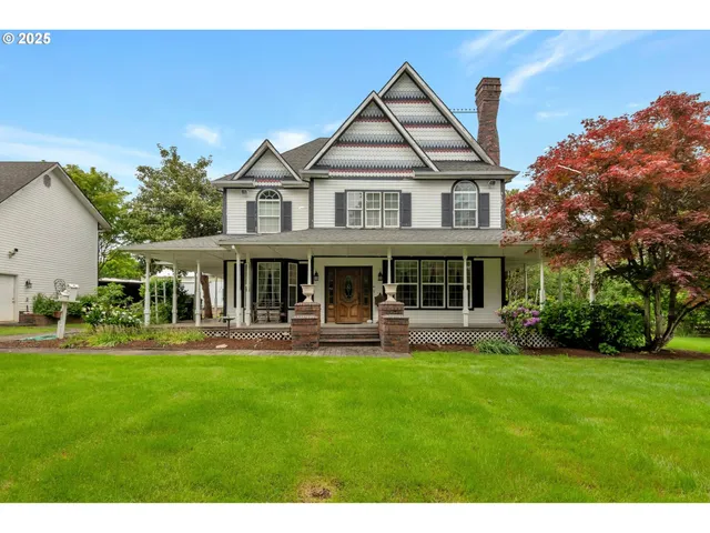 a front view of a house with a yard table and chairs