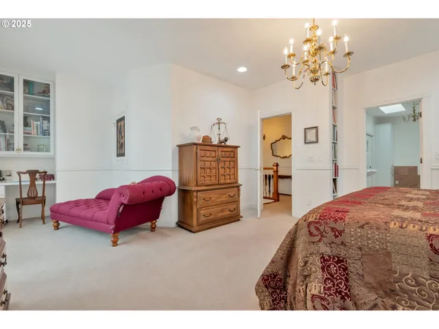 a bedroom with a bed and a chandelier