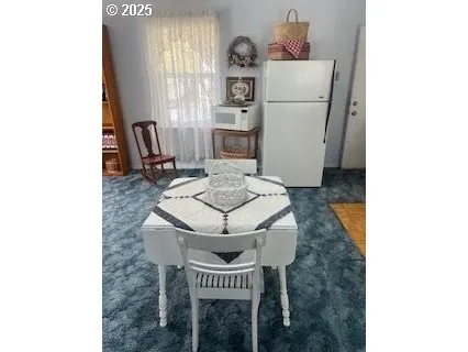 a kitchen with a refrigerator and a stove