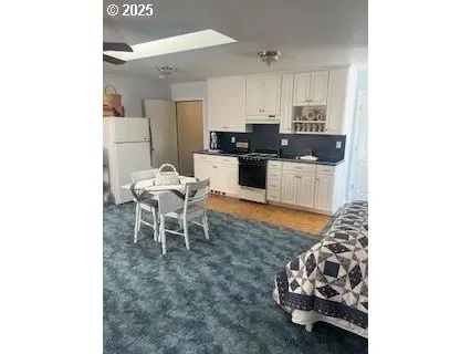 a living room with furniture and kitchen