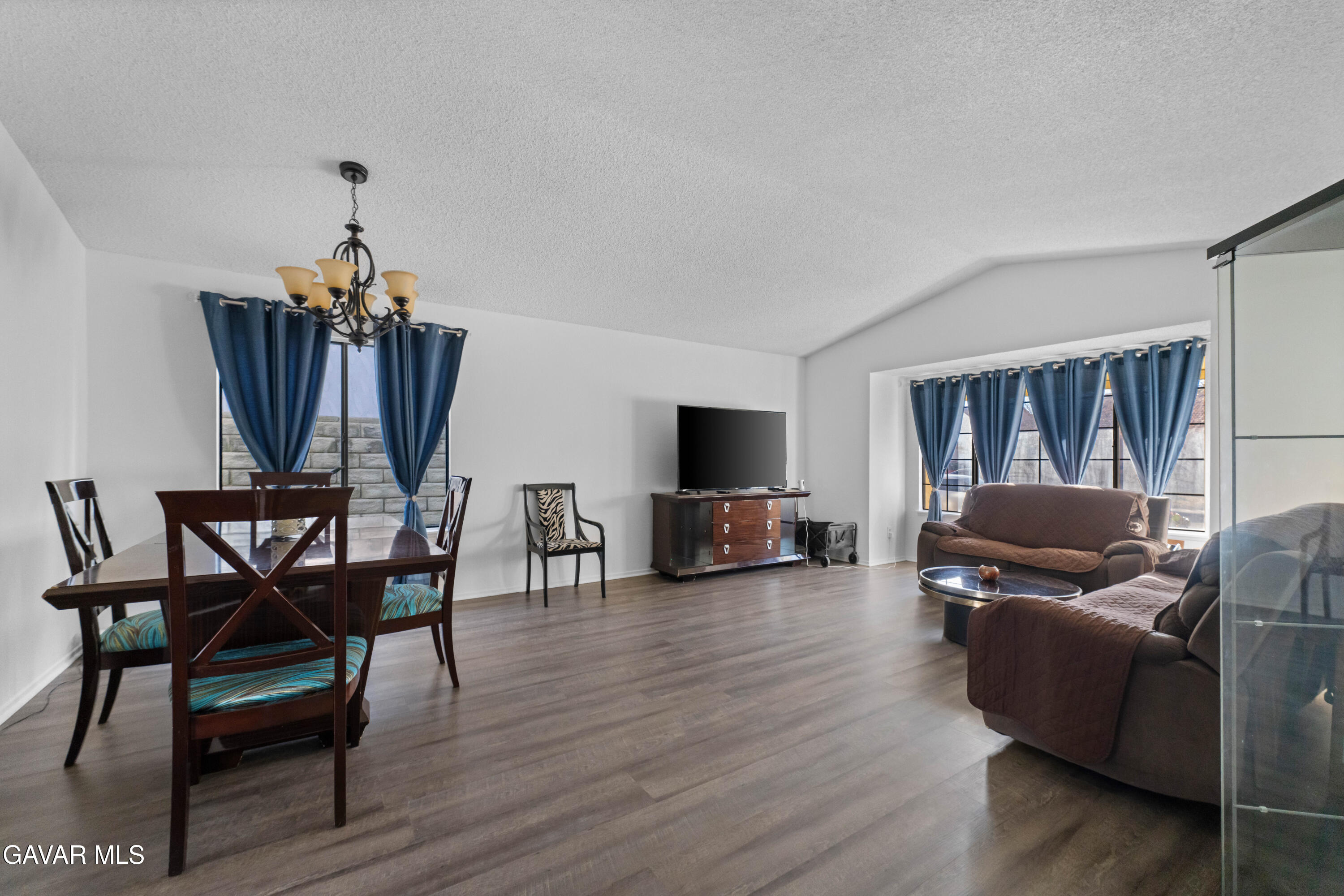 37720 Smoke Tree Street Palmdale, CA 93552 - Photo 14 of 16 a living room with furniture a fireplace and a flat screen tv