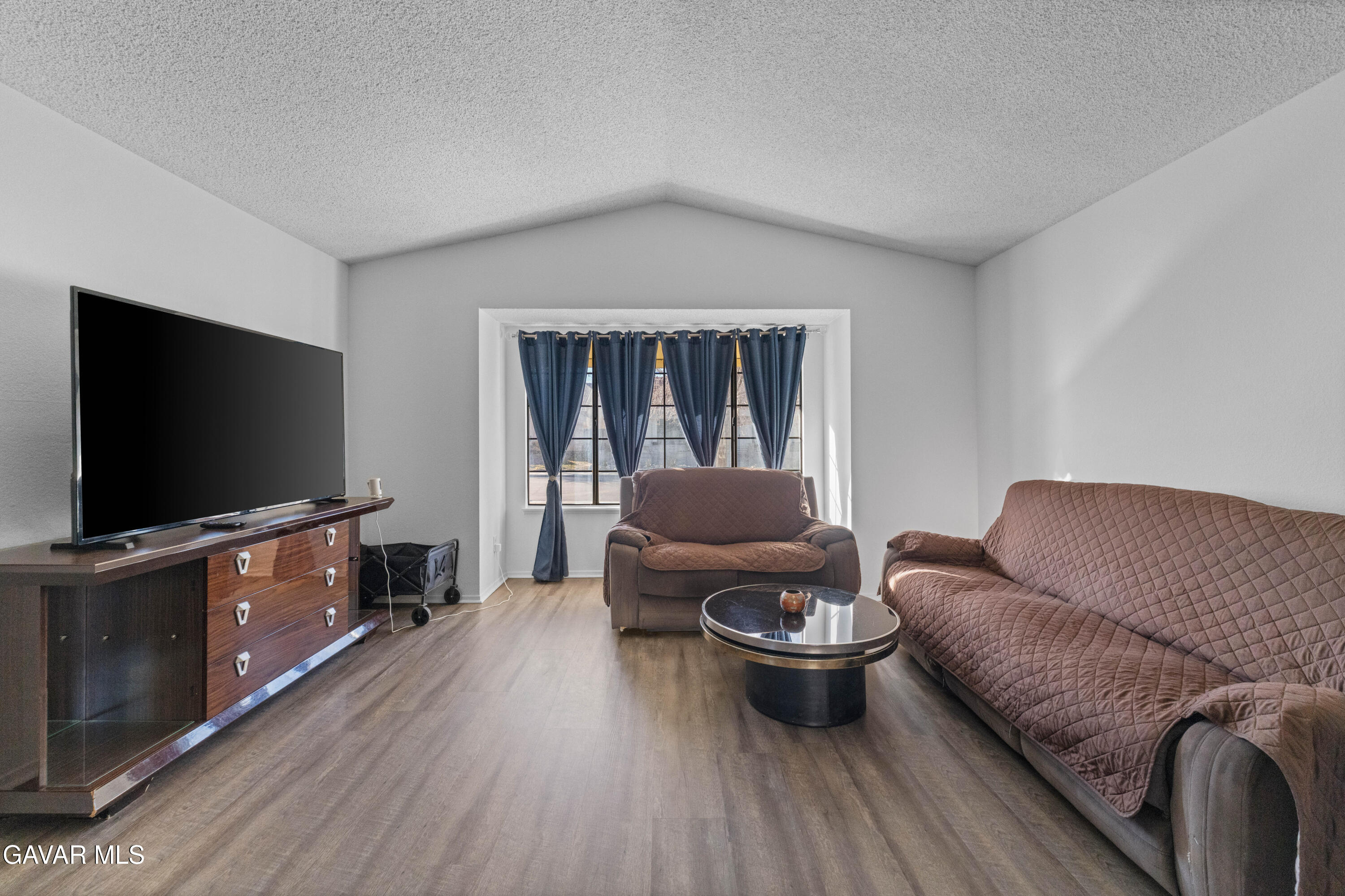 37720 Smoke Tree Street Palmdale, CA 93552 - Photo 15 of 16 a living room with furniture and a flat screen tv