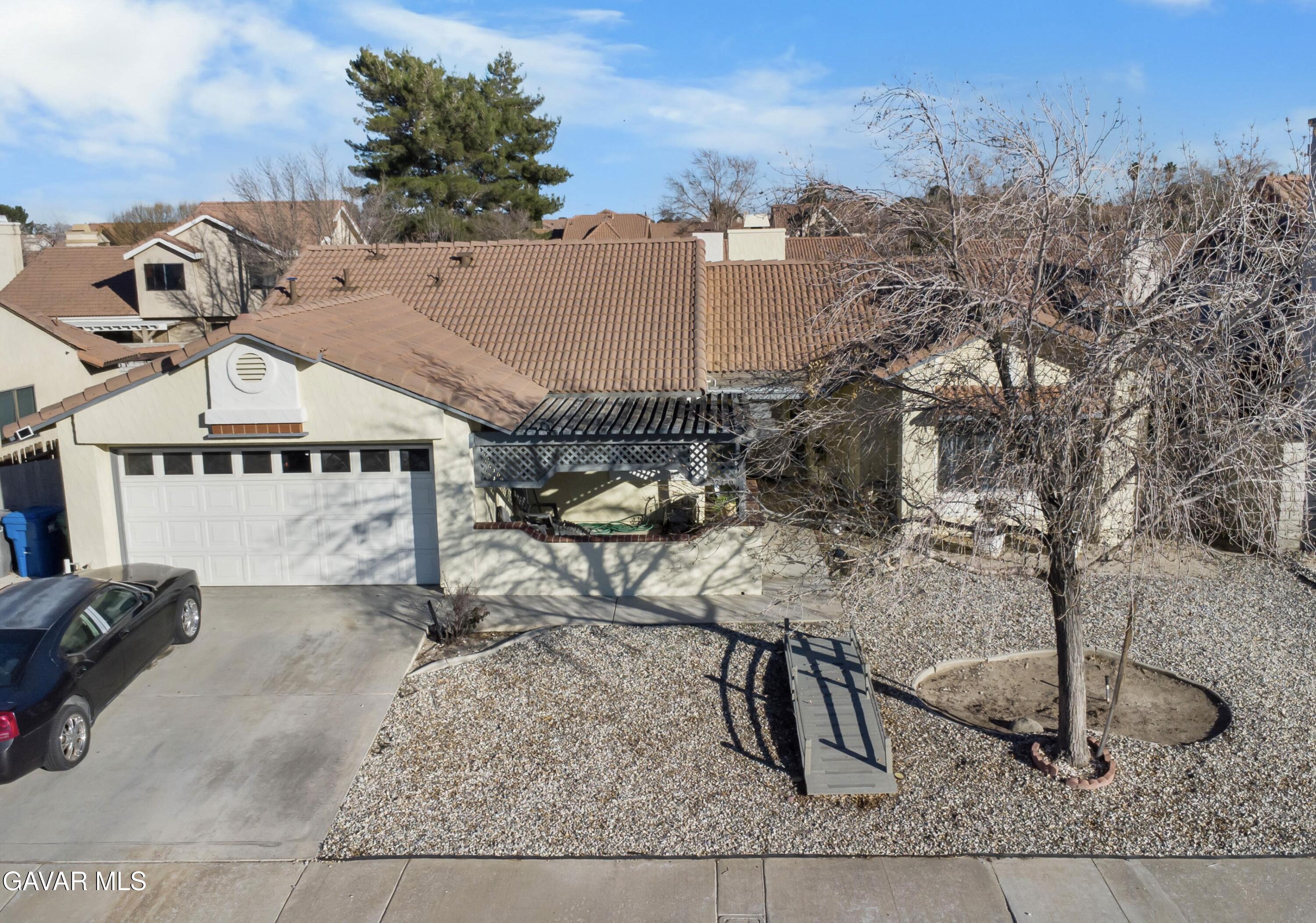 37720 Smoke Tree Street Palmdale, CA 93552 - Photo 17 of 17 a view of a house with large trees