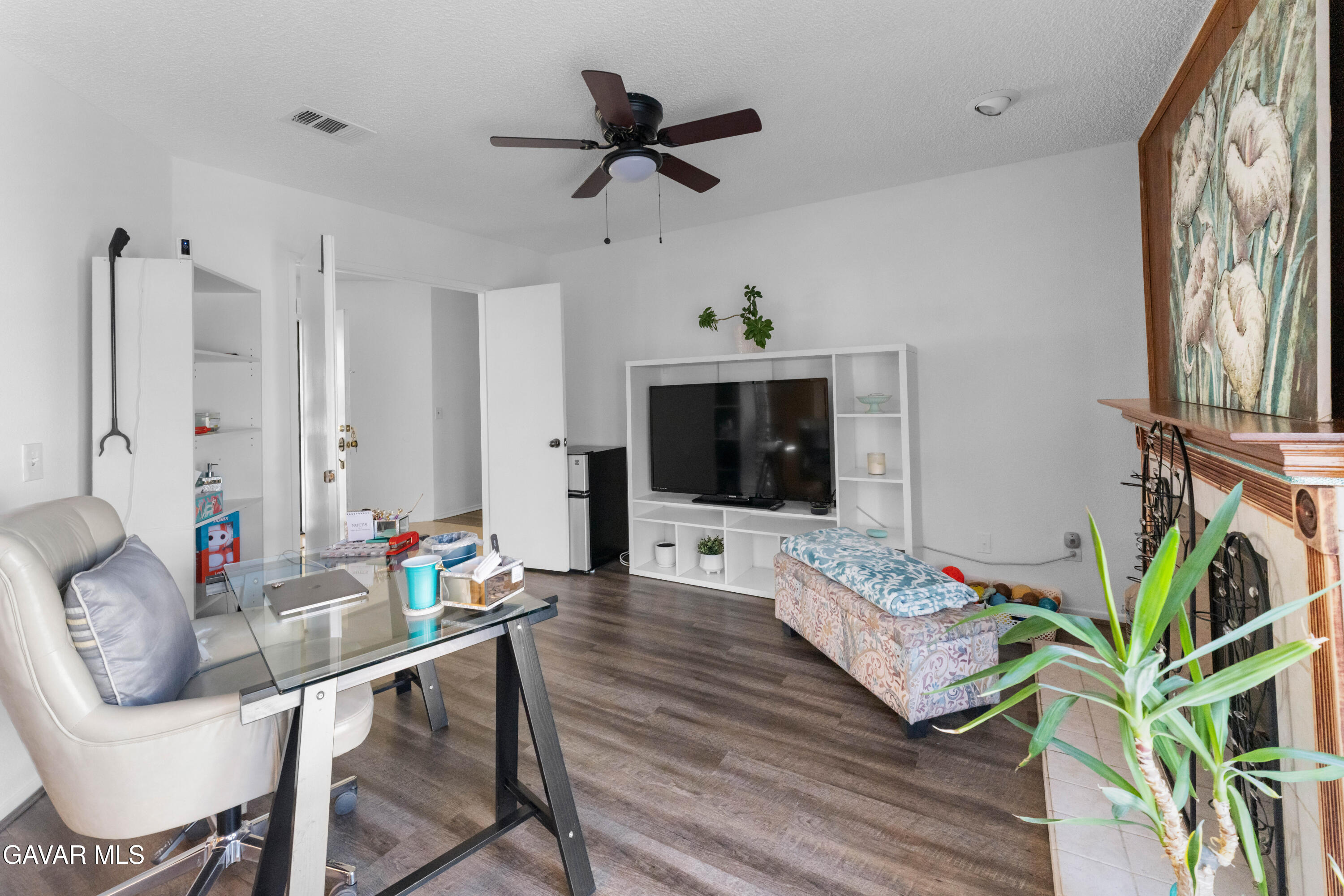 37720 Smoke Tree Street Palmdale, CA 93552 - Photo 4 of 16 a living room with furniture fireplace and a flat screen tv