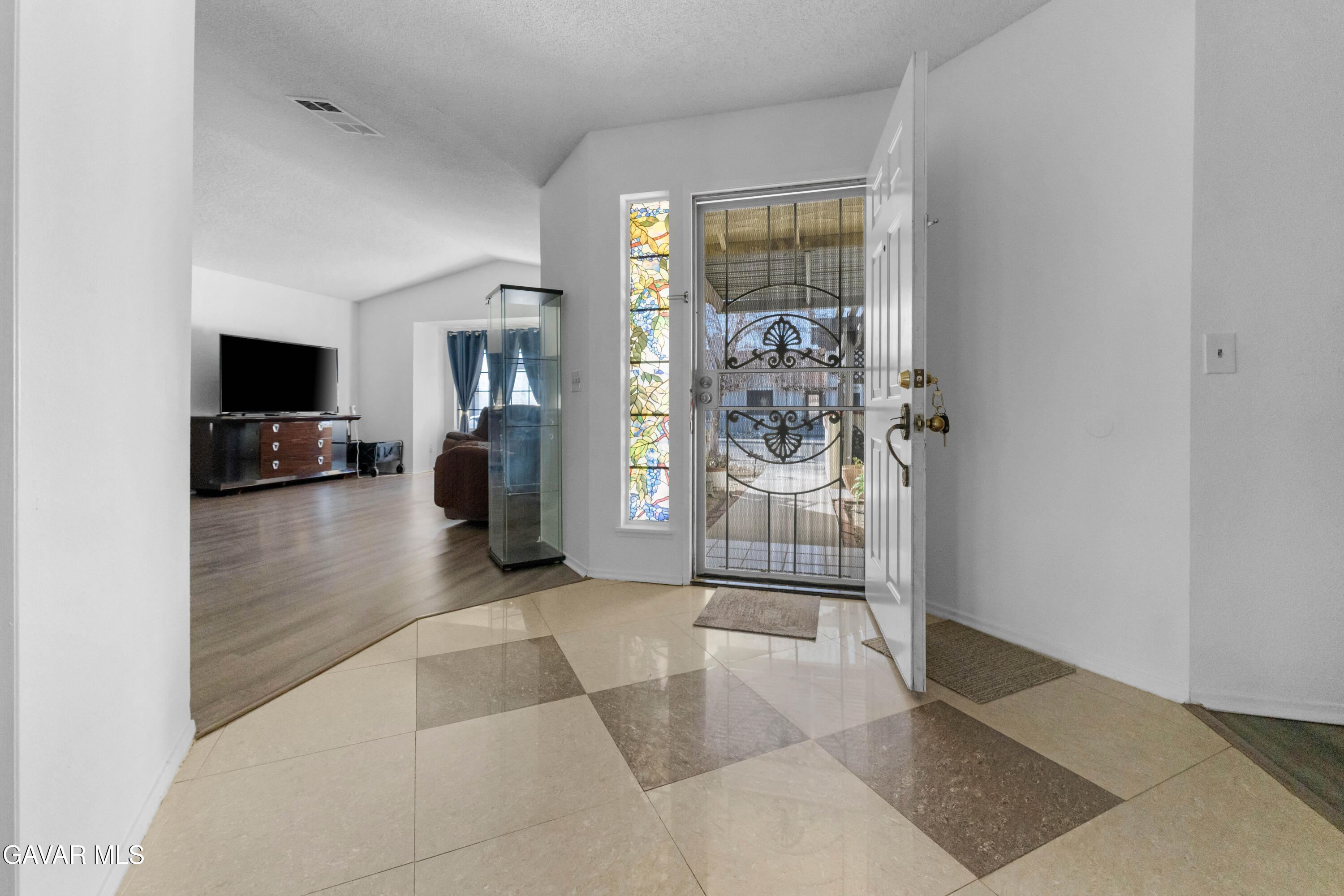 37720 Smoke Tree Street Palmdale, CA 93552 - Photo 5 of 17 a view of a livingroom with wooden floor and a flat screen tv