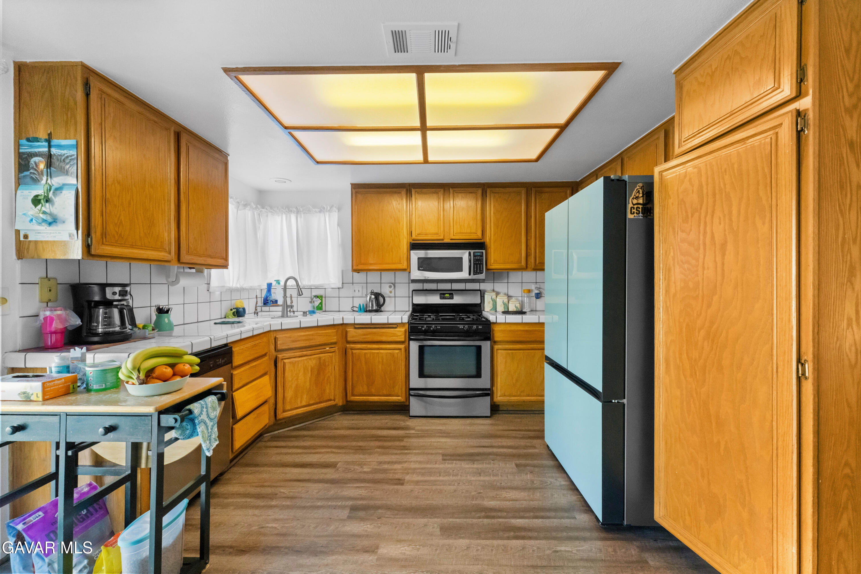 37720 Smoke Tree Street Palmdale, CA 93552 - Photo 6 of 17 a kitchen with stainless steel appliances granite countertop a stove a sink and a refrigerator