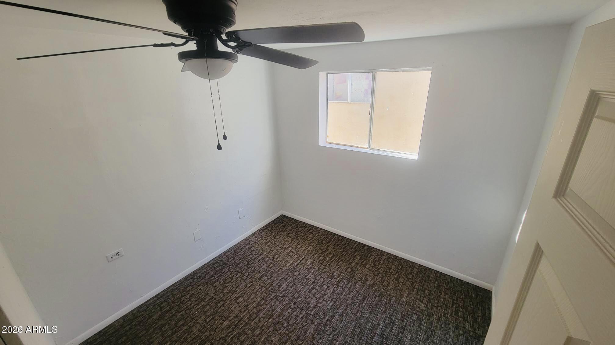 538 East E Avenue Douglas, AZ 85607 - Photo 13 of 14 a view of a room with a ceiling fan and a window