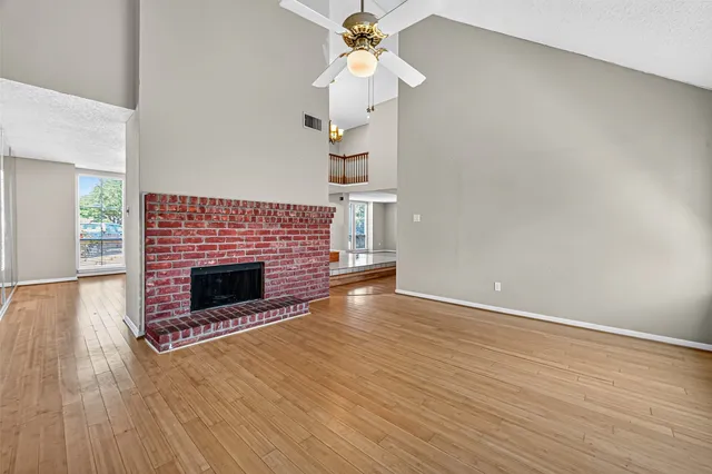 a view of a livingroom with wooden floor and stairs