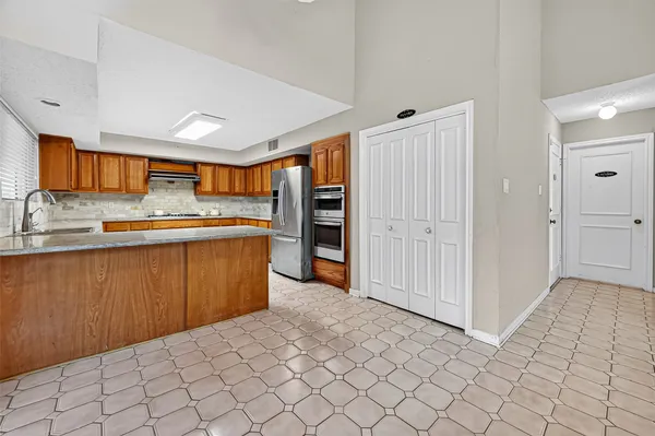 a kitchen with stainless steel appliances granite countertop a sink and cabinets