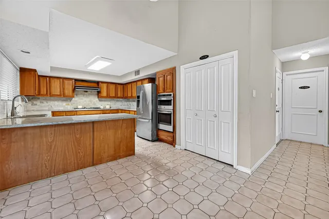 a kitchen with stainless steel appliances granite countertop a sink and cabinets