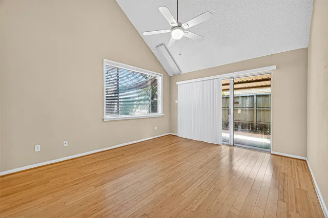 a view of empty room with wooden floor and fireplace