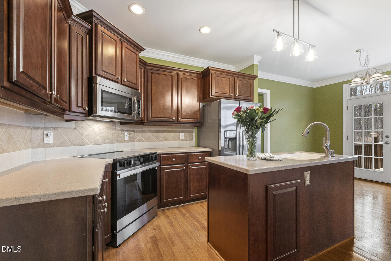 1119 Corrina Road Wake Forest, NC 27587 - Photo 15 of 45 a kitchen with stainless steel appliances granite countertop a sink stove and cabinets