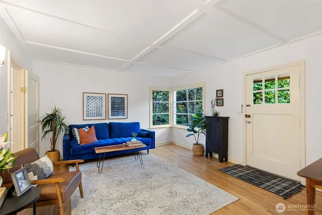a living room with furniture a window and a flat screen tv