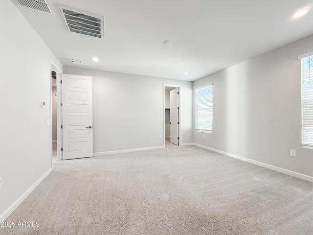 an empty room with a empty space and windows