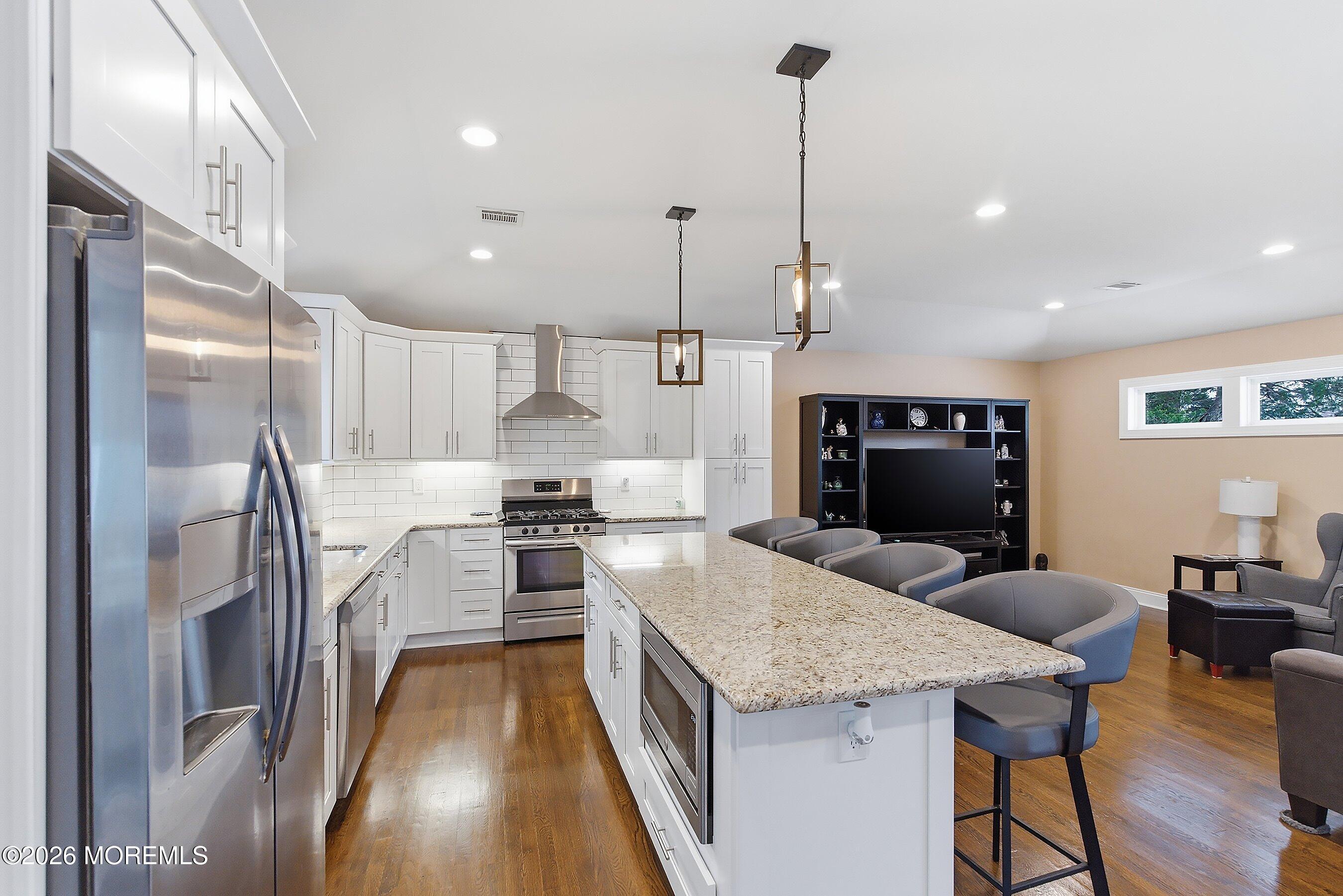 749 Hardean Road Brick, NJ 08724 - Photo 21 of 22 a open kitchen with stainless steel appliances granite countertop a stove and refrigerator