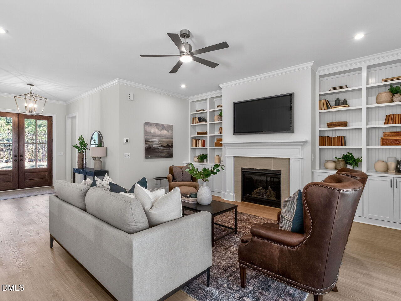 8912 Thompson Mill Road Wake Forest, NC 27587 - Photo 12 of 41 a living room with furniture a fireplace and a flat screen tv