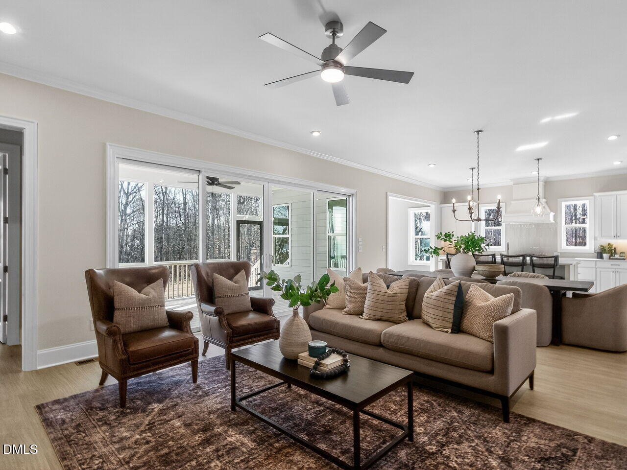 8912 Thompson Mill Road Wake Forest, NC 27587 - Photo 13 of 41 a living room with furniture potted plant and a chandelier