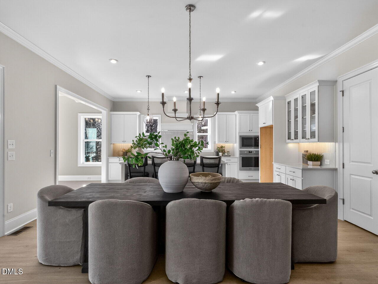 8912 Thompson Mill Road Wake Forest, NC 27587 - Photo 14 of 41 a dining room with furniture a potted plant and kitchen view