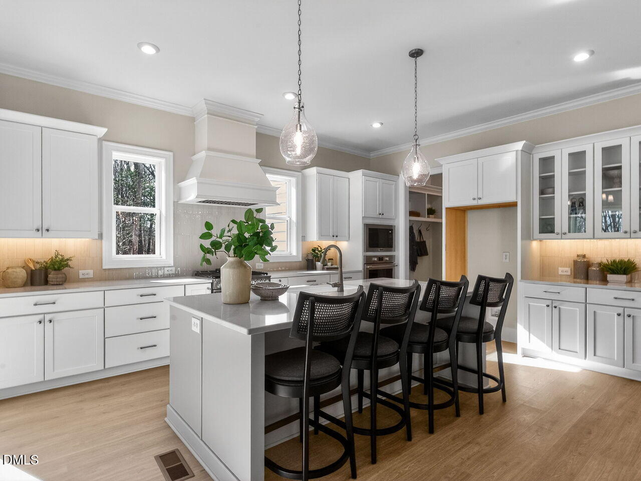 8912 Thompson Mill Road Wake Forest, NC 27587 - Photo 16 of 41 a kitchen with stainless steel appliances kitchen island granite countertop a table chairs and white cabinets