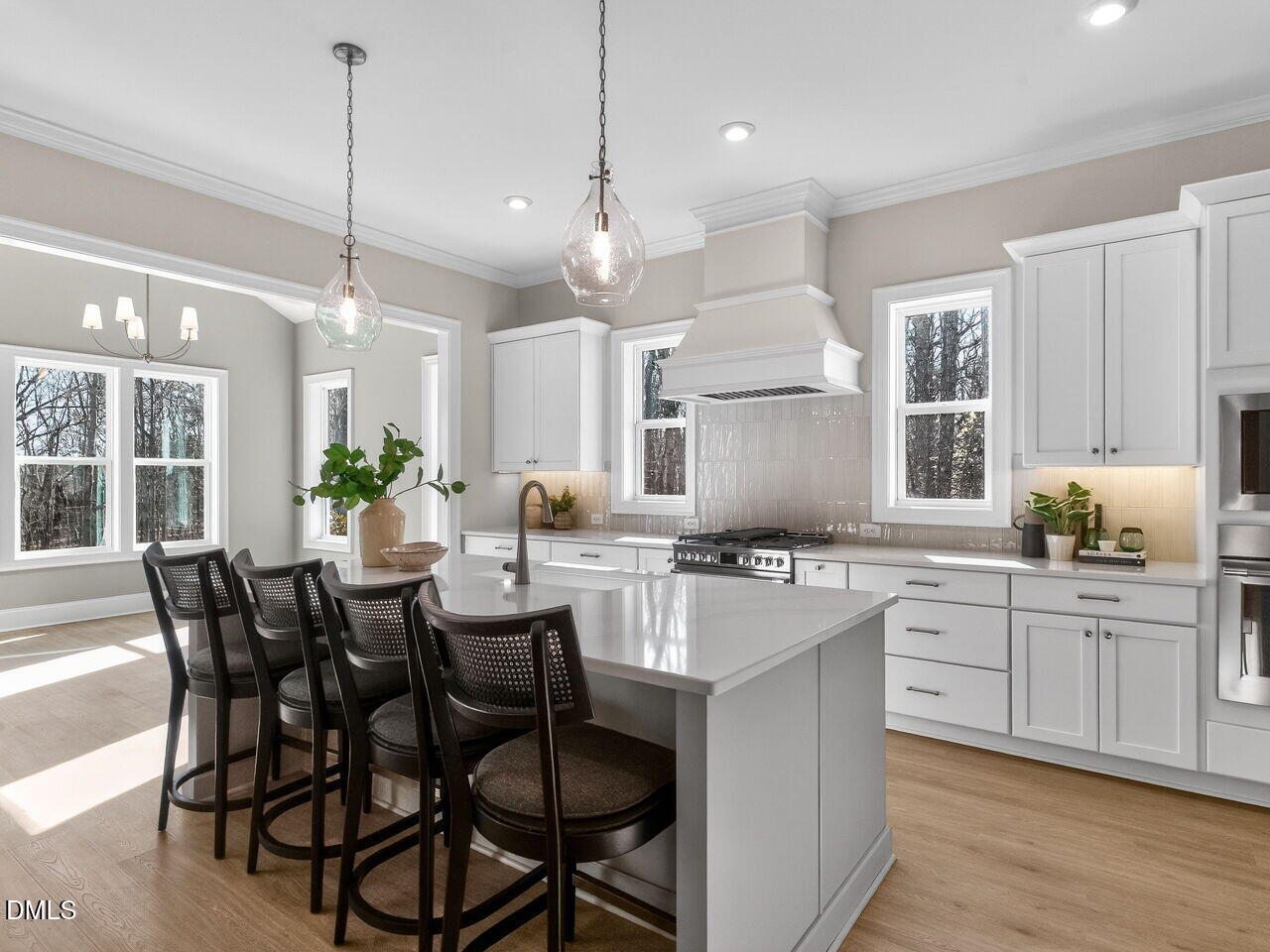 8912 Thompson Mill Road Wake Forest, NC 27587 - Photo 18 of 41 a kitchen with kitchen island a dining table and chairs