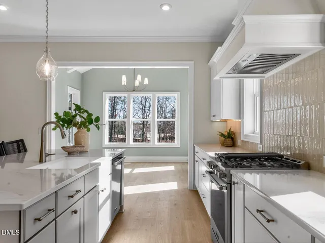 a kitchen with stainless steel appliances granite countertop a sink stove and cabinets