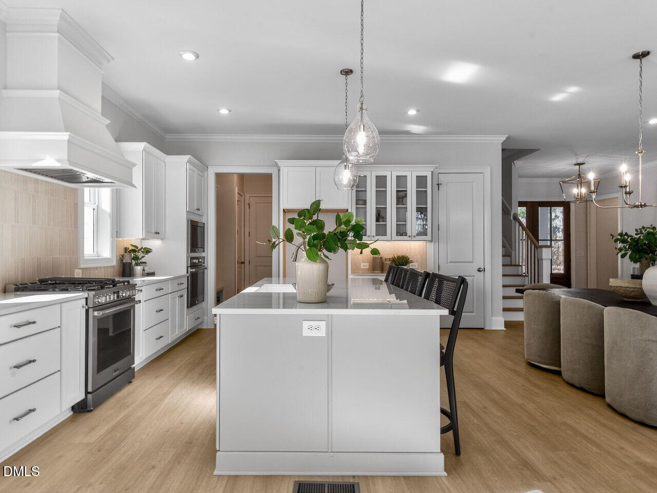 8912 Thompson Mill Road Wake Forest, NC 27587 - Photo 22 of 41 a view of a kitchen with kitchen island and stainless steel appliances