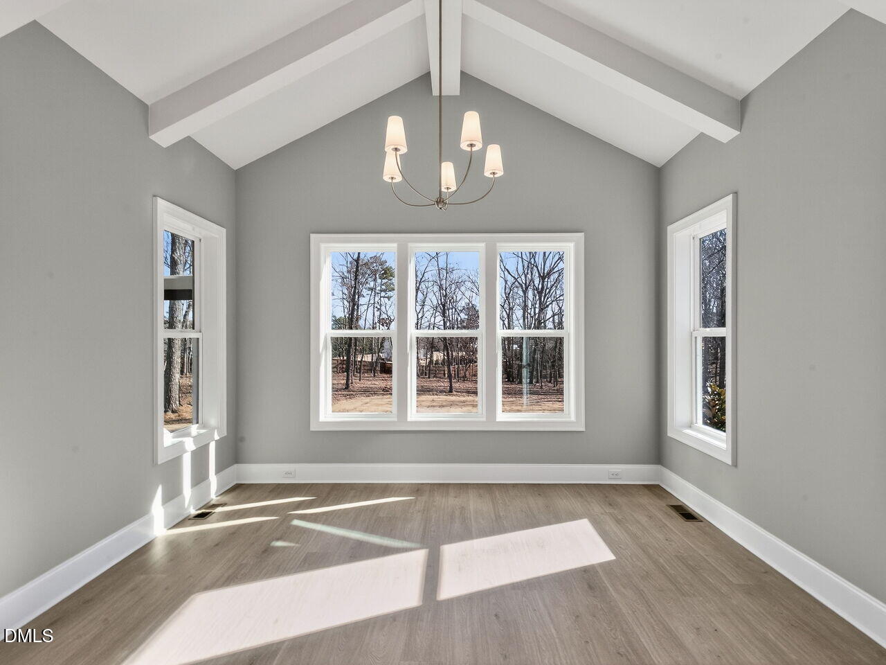 8912 Thompson Mill Road Wake Forest, NC 27587 - Photo 25 of 41 an empty room with wooden floor and windows