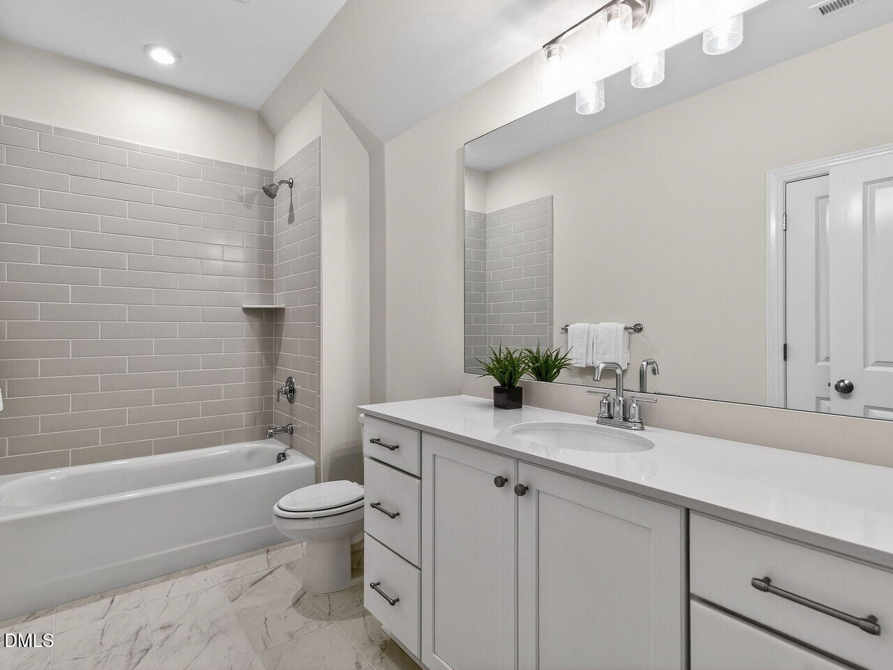 8912 Thompson Mill Road Wake Forest, NC 27587 - Photo 39 of 41 a bathroom with a granite countertop sink a toilet and shower