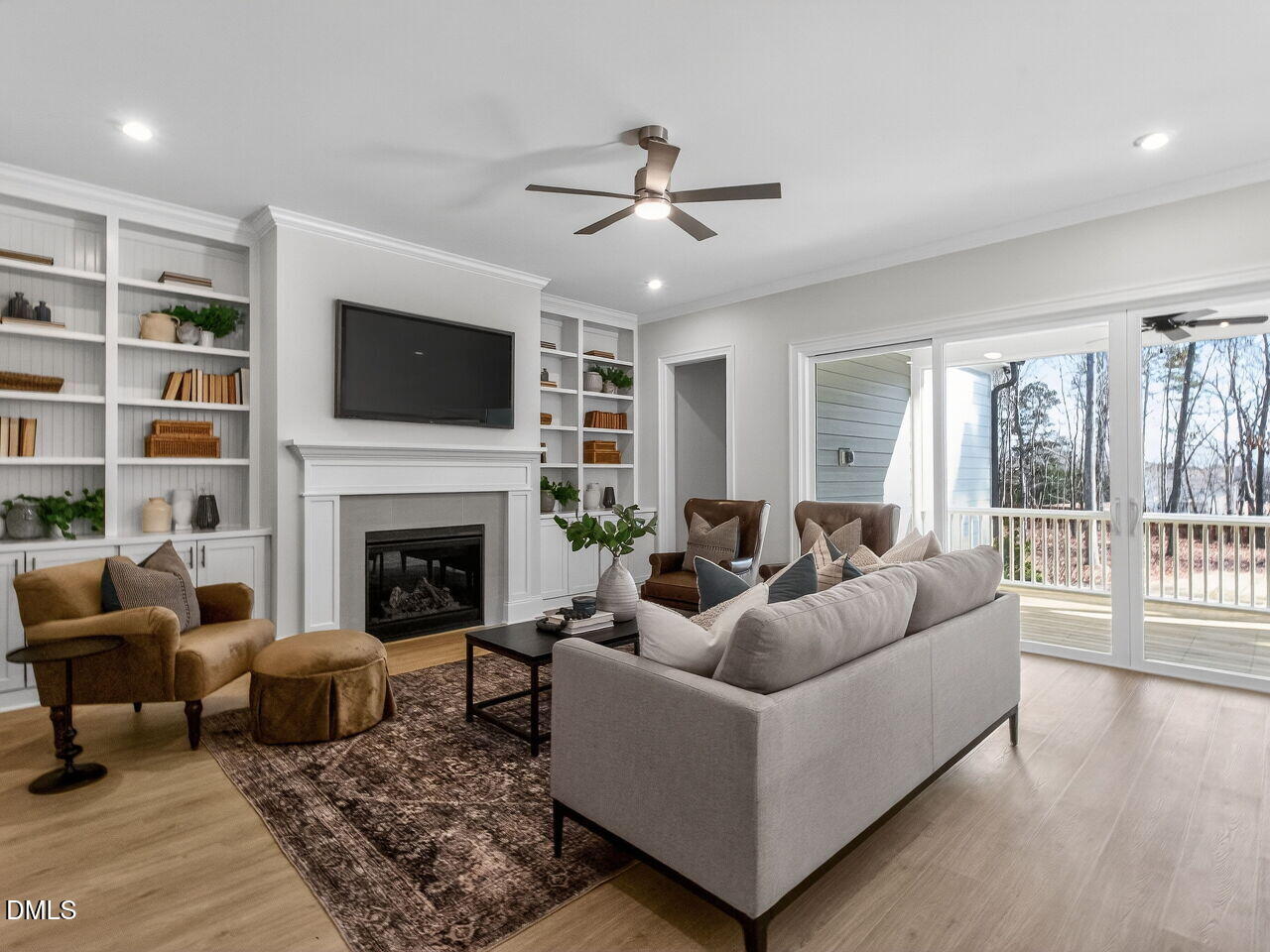 8912 Thompson Mill Road Wake Forest, NC 27587 - Photo 10 of 41 a living room with furniture a flat screen tv and a fireplace