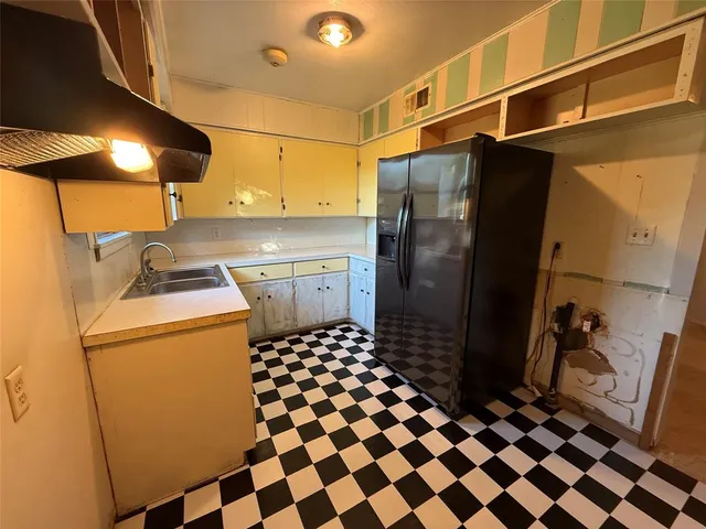a kitchen with a refrigerator and a stove