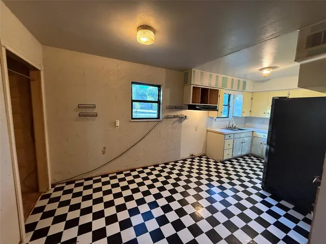 a black and white kitchen with a sink