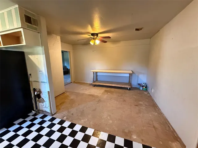 a bedroom with a bed and a ceiling fan