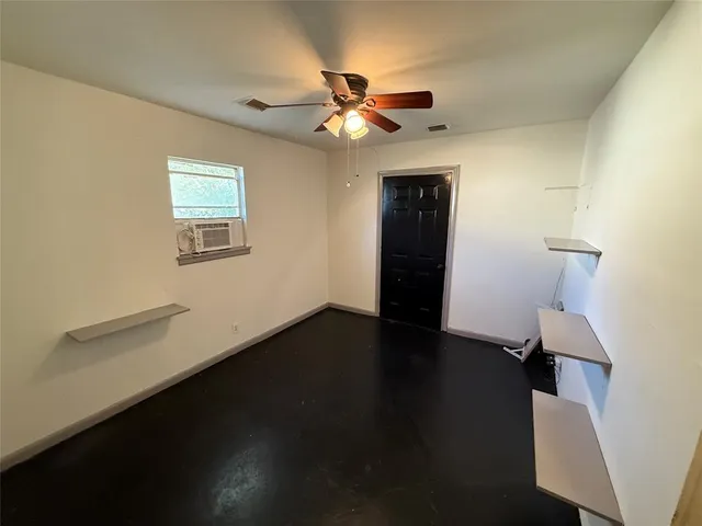 a view of a livingroom with a hardwood floor and a ceiling fan