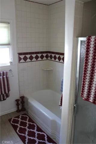 a bathroom with a bathtub and a shower