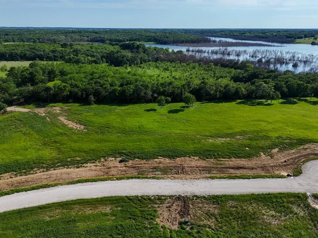 a view of a garden with a building in the background