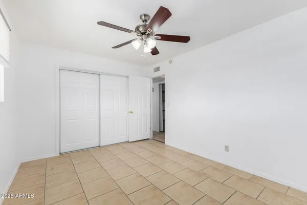 a view of a room with window and ceiling fan
