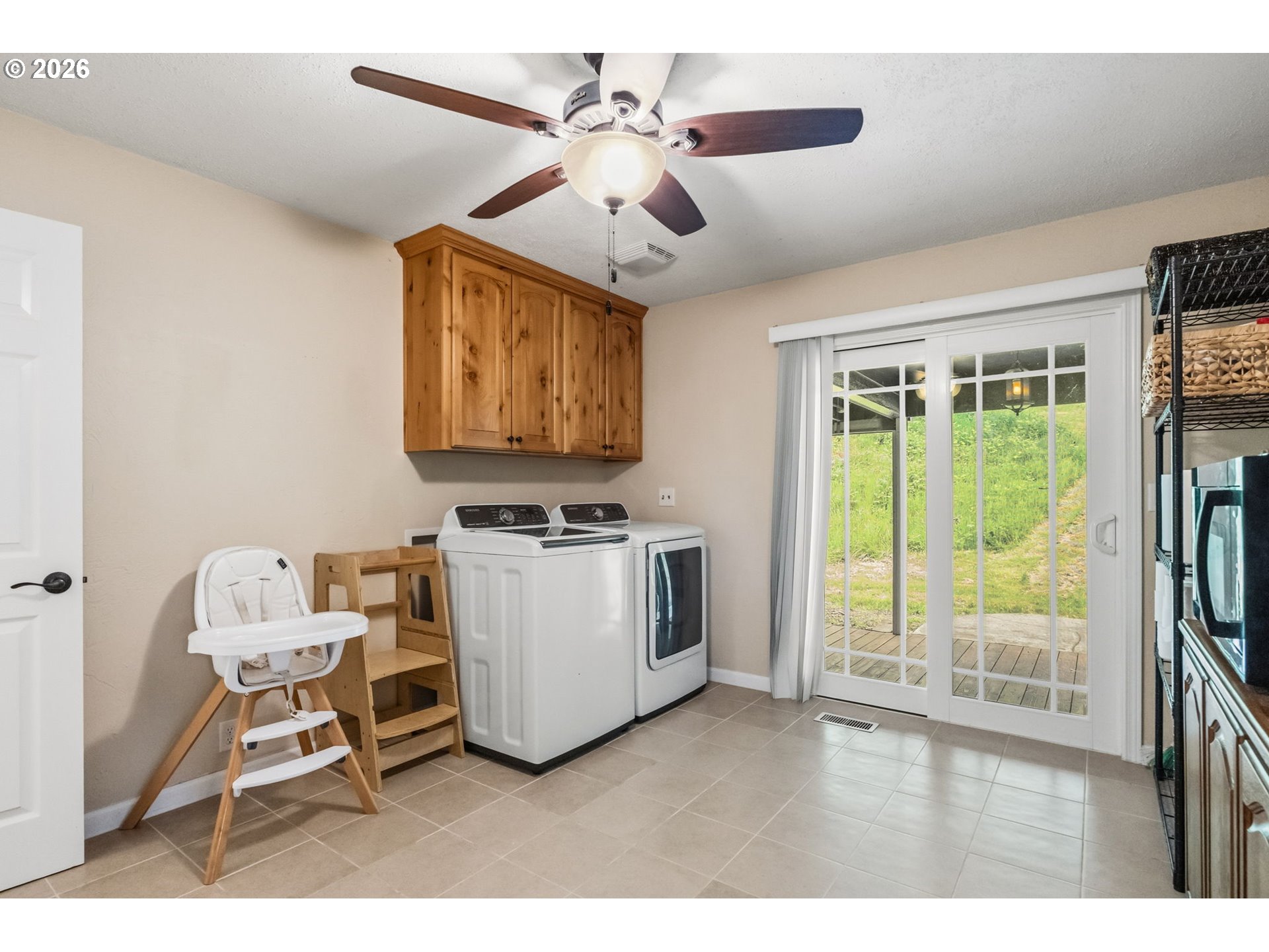 89093 Marcola Road Springfield, OR 97478 - Photo 21 of 25 a living room with furniture a flat screen tv and a floor to ceiling window