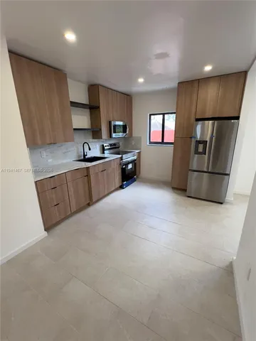 a kitchen with stainless steel appliances a refrigerator and a sink